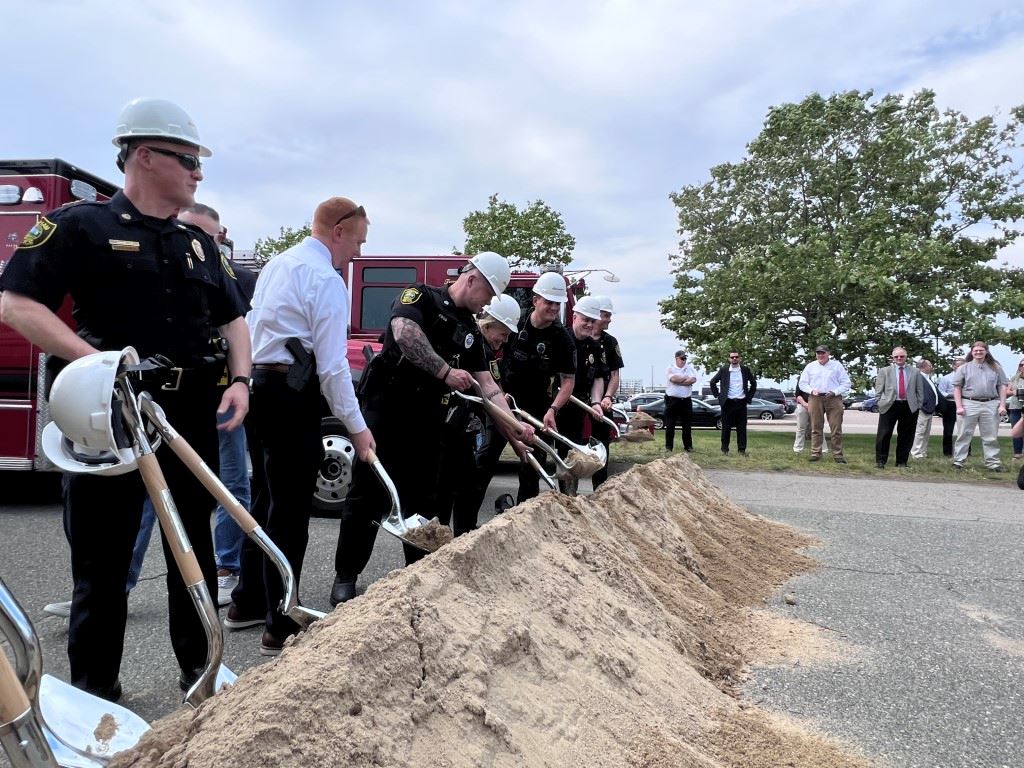 Groundbreaking people with shovels and hardhats